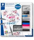 Staedtler Brush Lettering Design Journey Pack con 6 Rotuladores Pigment Art para Lettering en Colores Surtidos, Lapiz, Goma de B